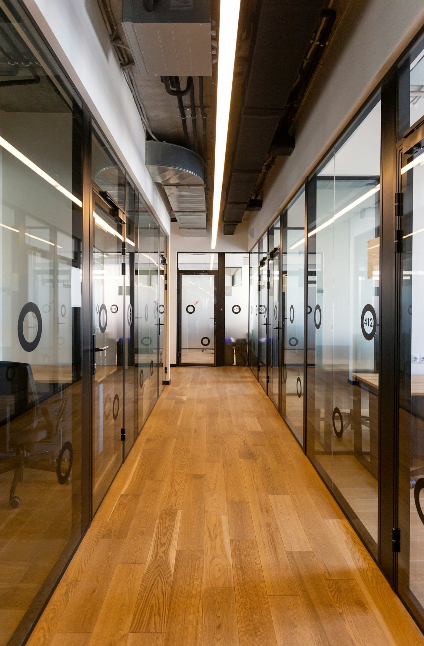 Corridor lined with glass office partitions